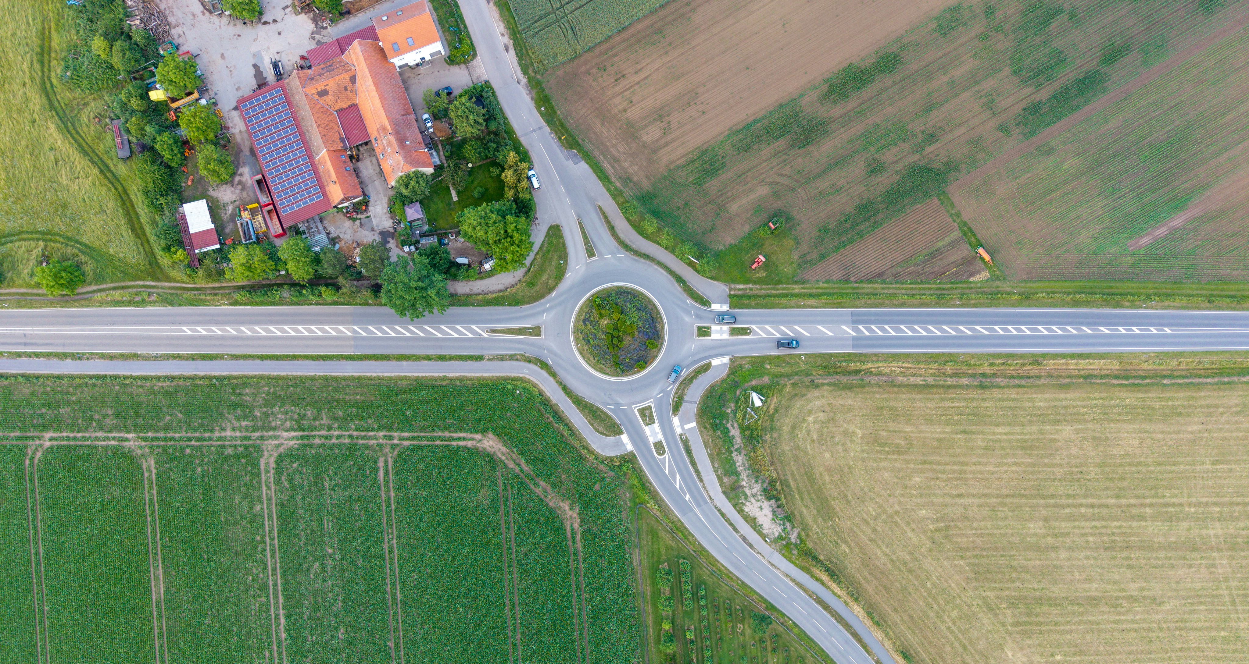 Aerial view of a rural roundabout surrounded by farm fields